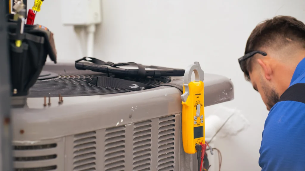 pollux air hvac specialist utilizing tools to fix ac unit