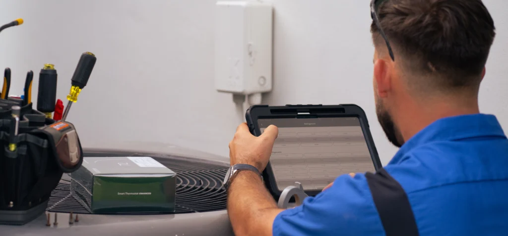 pollux air hvac specialist diagnosing ac problems with tablet